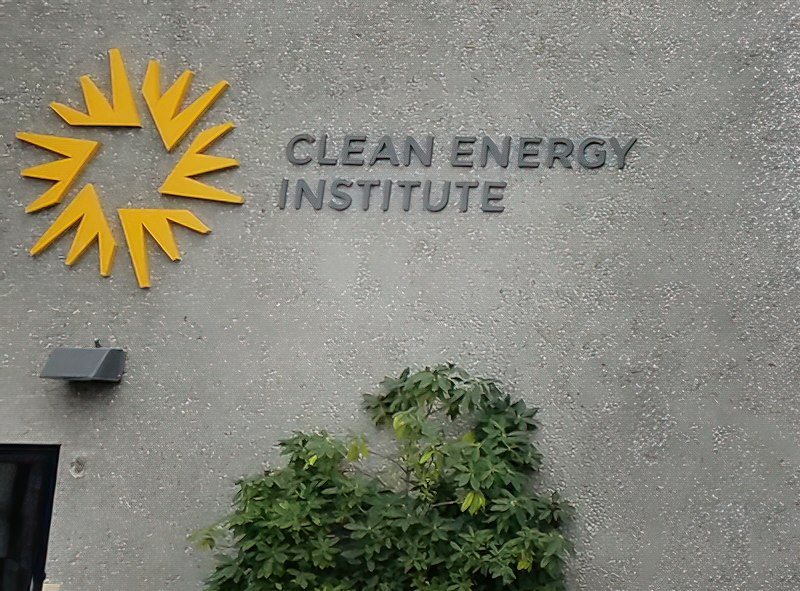 yellow uw clean energy institute sign on exterior of building