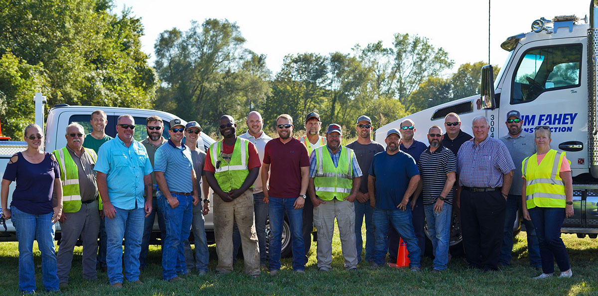 jm fahey construction team standing in front of truck with logo