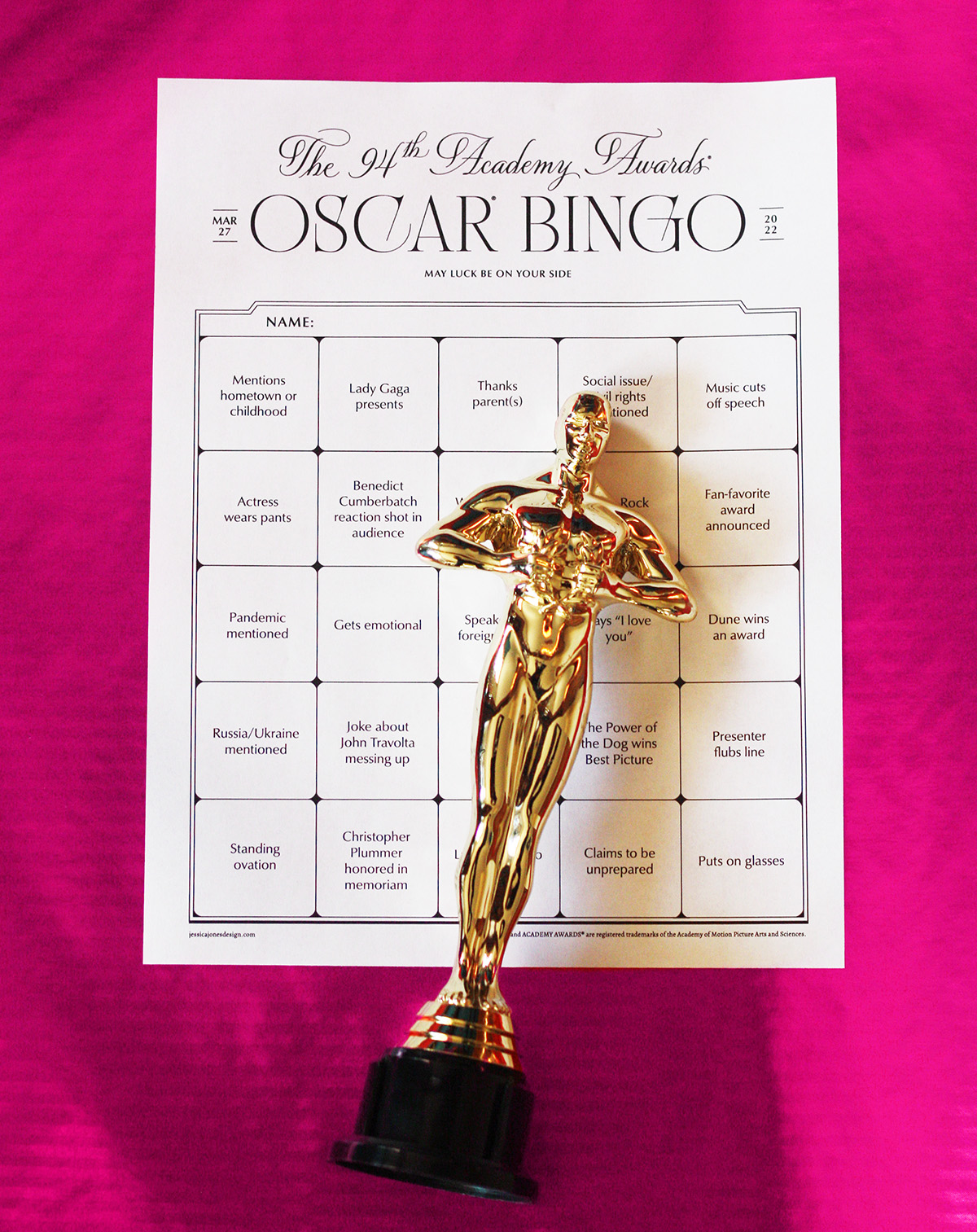 academy awards bingo party game card 2022 with gold oscar statue on pink background