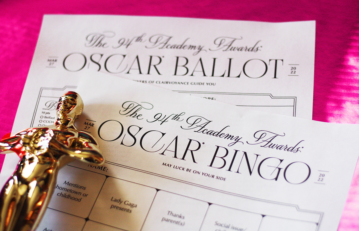 closeup of oscar bingo card w ballot on pink background