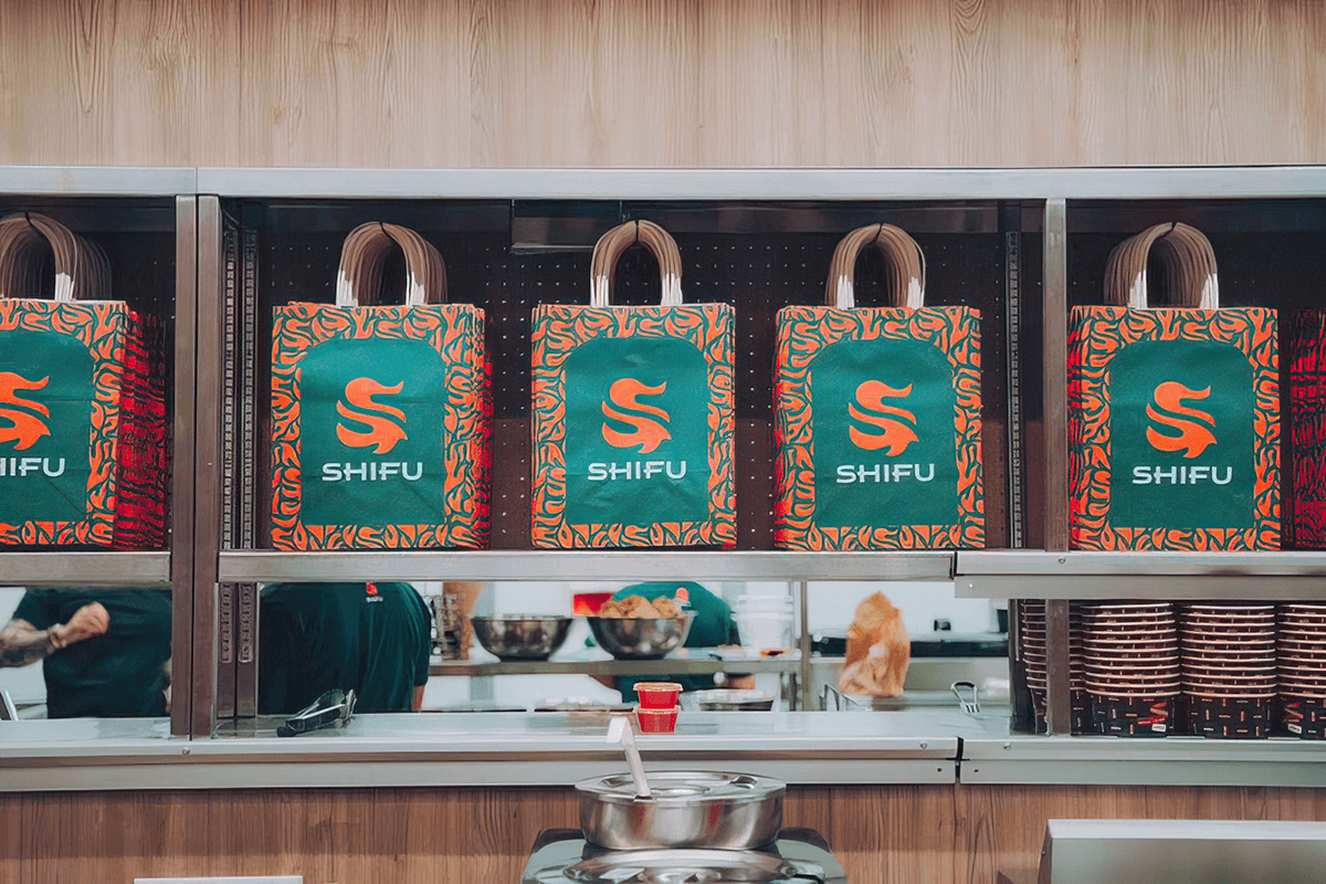 chinese take-out food bags in a row on a shelf