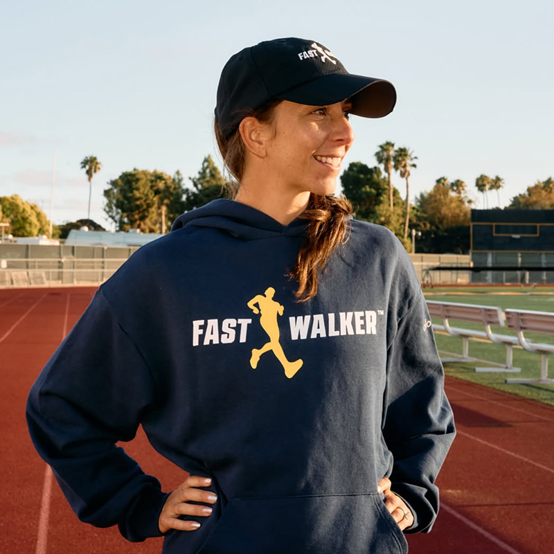 Miranda Melville wearing a navy blue sweatshirt with a yellow and white Fastwalker logo