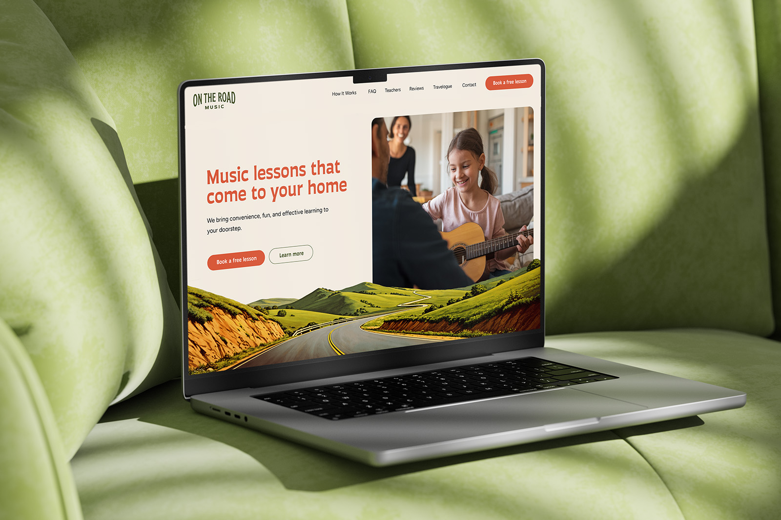 a laptop showing a music school home page resting on a sofa
